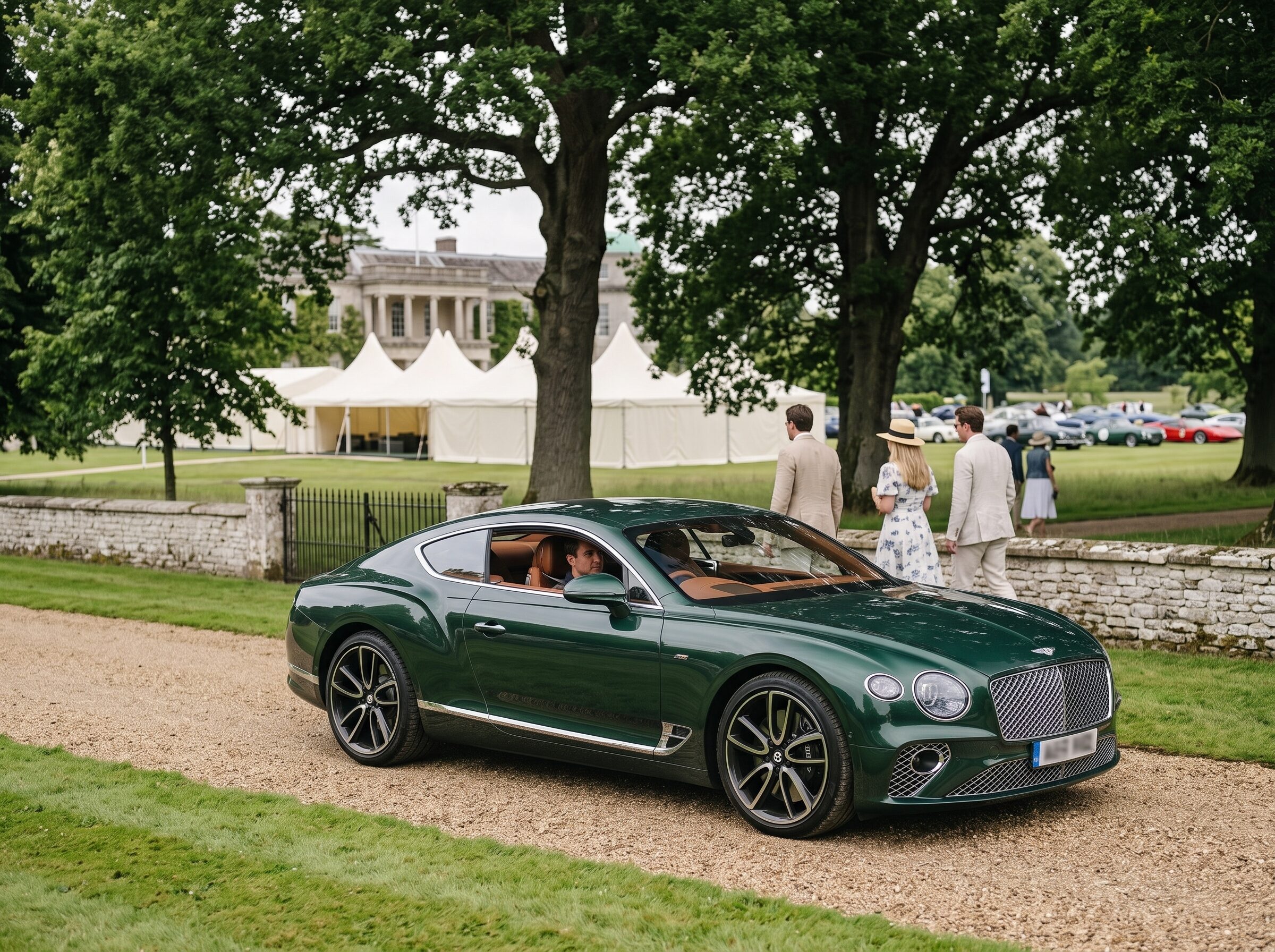 A grand tourer prepared near a country estate gathering during Goodwood week