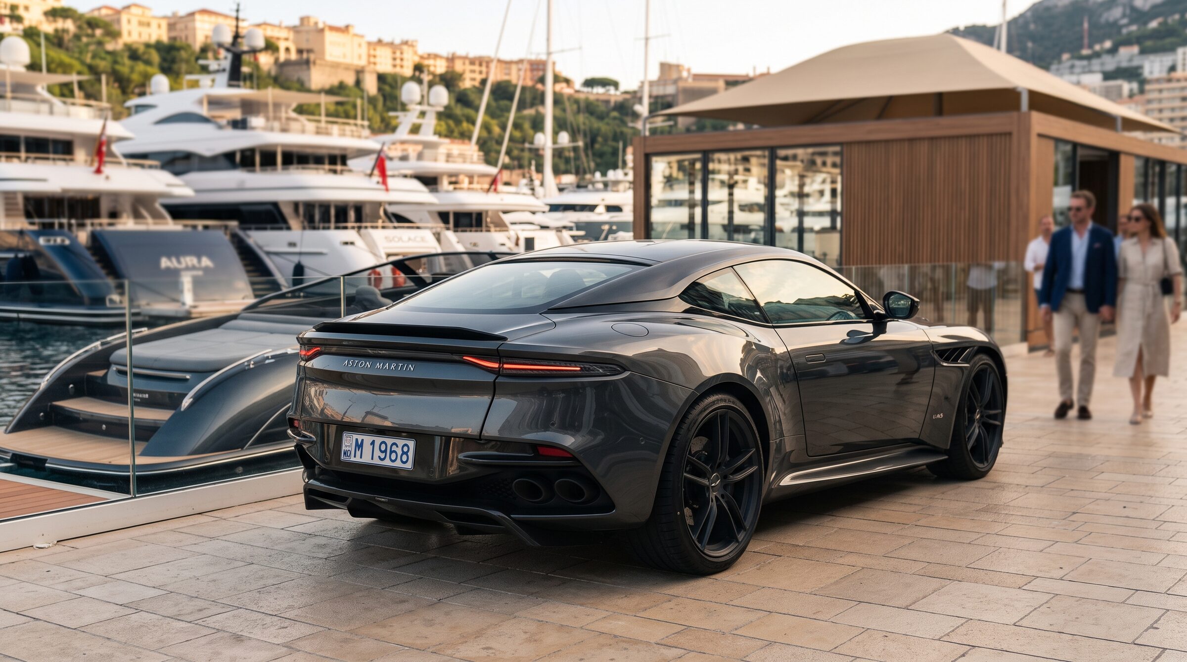 A grand tourer beside superyachts and the exhibition area at Port Hercule