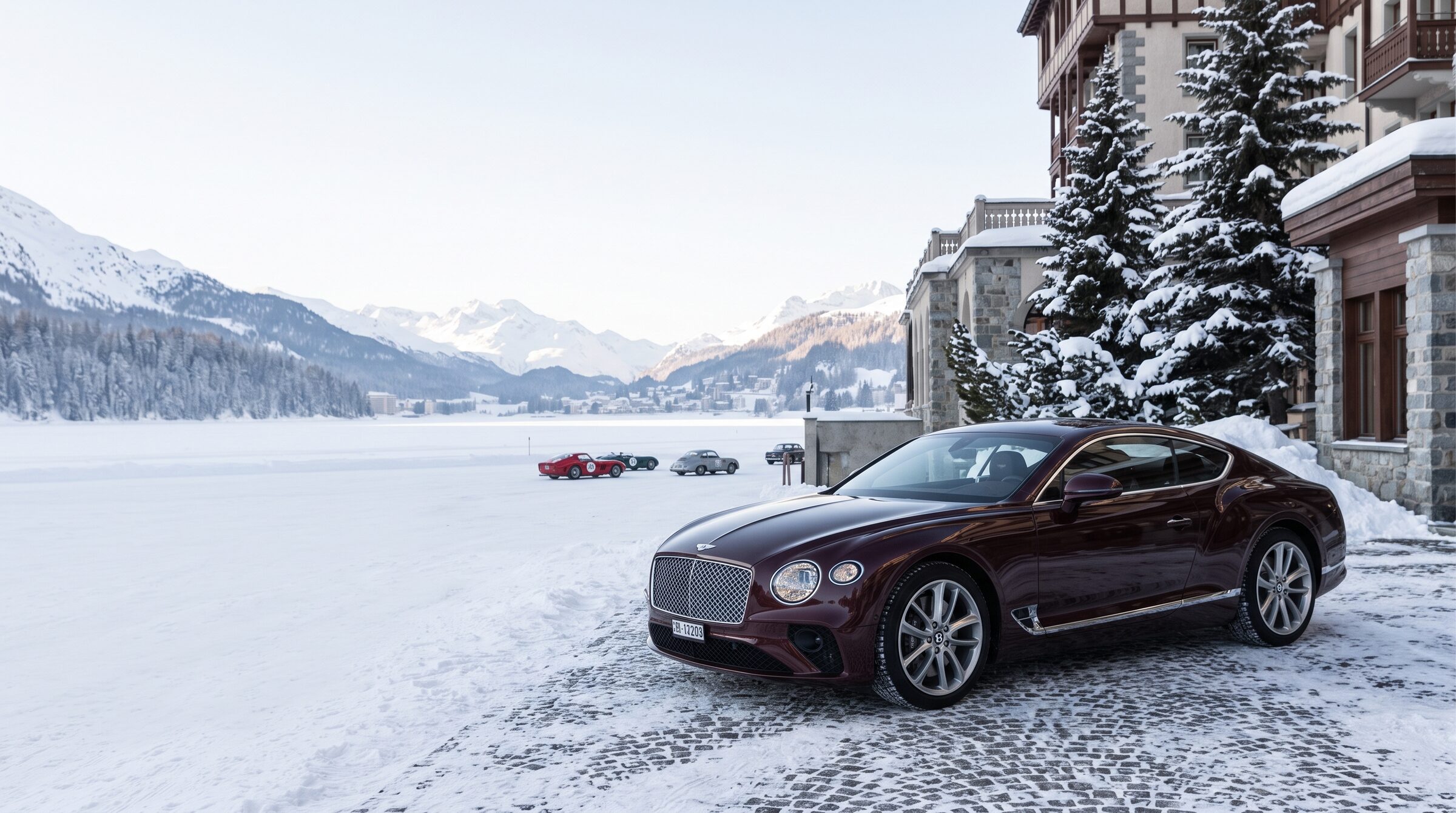 An oxblood grand tourer prepared beside the frozen lake in St. Moritz